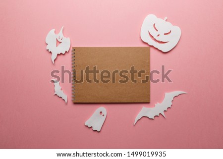 Halloween decorations. Halloween paper decorations on pastel pink background. Top view. Flat lay of accessory decoration Halloween festival. Copy space. Minimal creative concept. Pastel colors