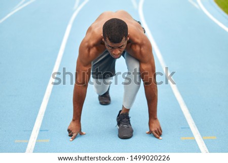serious active ambitious athlete taking part in the marathon. full length photo
