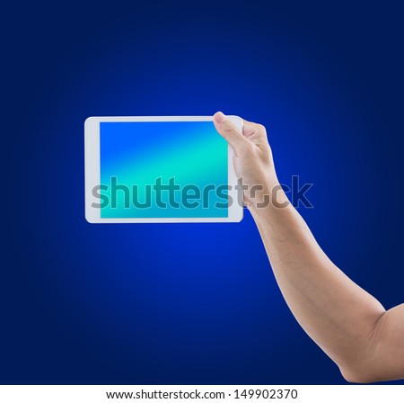 Man hand hold digital tablet on blue background