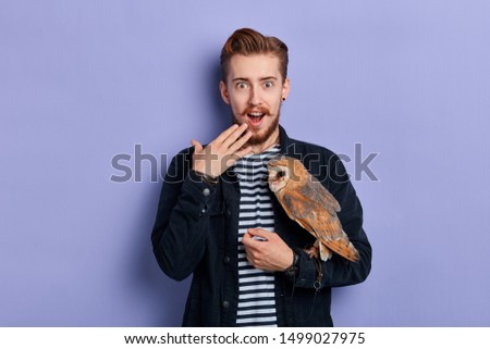 excited happy young man expresses happiness positive emotion and feeling, close up portrait, isolated blue background, studio shot