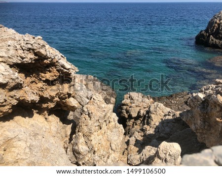 Turquoise Mediterranean sea in bay of chalk in Chios Greece.