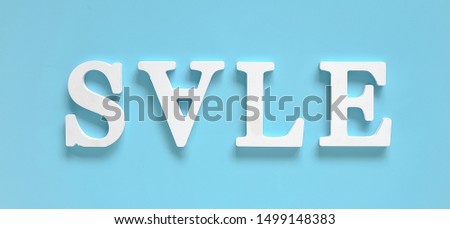 Inscription SALE from white volume letters on blue background. Top view Flat lay Banner Concept hot discount. Creative template for your text, design, ad or advertisement.