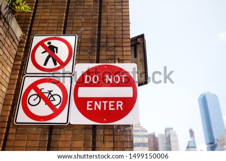 Prohibitive traffic sign on brick wall of street in New York City. No entry for people and bike. Road signs in NYC.