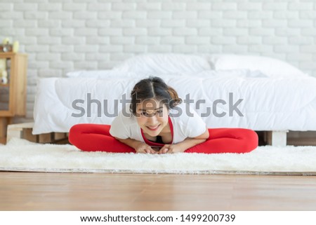 Happy Attractive Asian woman practice yoga baddha konasana pose with meditation smile with big belly after wake up in the morning Feeling so comfortable and relax,Healthcare Concept