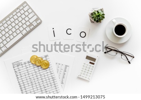 Initial coin offering ICO with coins, calculation table, office tools, coffee on white background top view