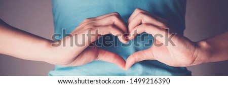 Woman hands making a heart shape on her stomach, healthy bowel degestion, probiotics  for gut health, leaky gut, woman health Royalty-Free Stock Photo #1499216390