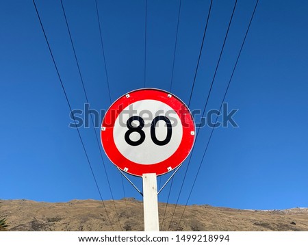 Speed ​​limit sign 80 kilometers per hour with the electric wire the blue sky.