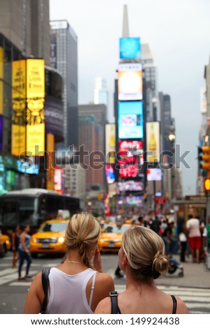 Two beautiful girls on Times Square in New York City. Shallow focus.