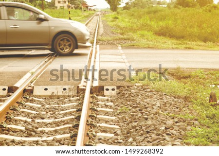 A moving blur passenger car crossing the railroad. Train road.