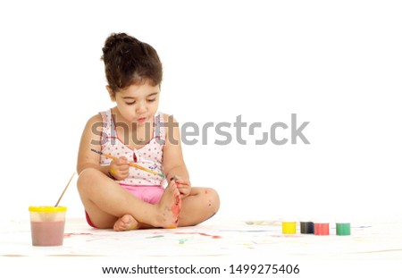 Portrait of young girl painting picture on a white background
