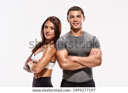 Portrait of two young fit sporty people with crossed hands Royalty-Free Stock Photo #1499277197