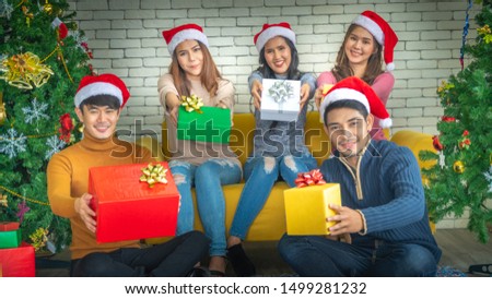 Teenagers, both men, and women, organize New Year's events, take pictures with mobile phones and give gifts. Drink happily Help each other decorate the Christmas tree.