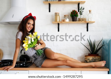 Beautiful young happy woman on the kitchen
