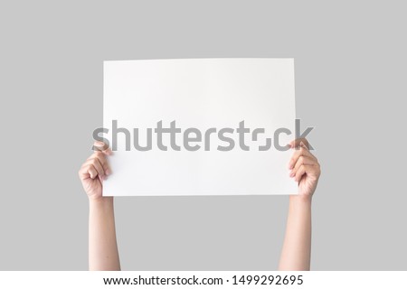 hand holding white blank paper isolated on grey background with clipping path