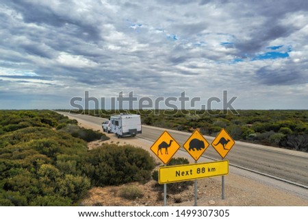 Aerial view of outback Australia travelling on the road with a caravan and 4wd