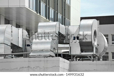 Industrial air conditioning and ventilation systems on a roof Royalty-Free Stock Photo #149931632