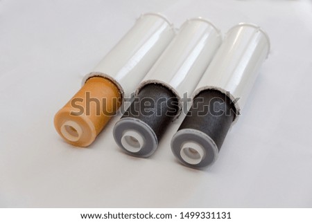 Used filter cartridges on white background. Aqua. Clear water. Health. Technology.