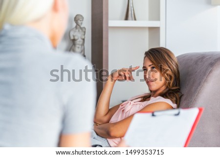 Woman at therapy session. Attentive psychologist. Young woman at psychotherapy thinking about advice she received