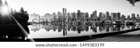 Panoramic view of Vancouver skyline at sunrise as seen from Stanley Park, British Columbia, Canada.