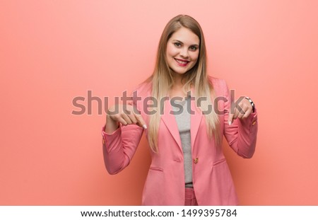 Young russian woman wearing pajama pointing to the bottom with fingers
