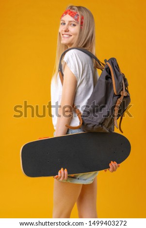 Portrait of a  young girl in short shorts with longboard