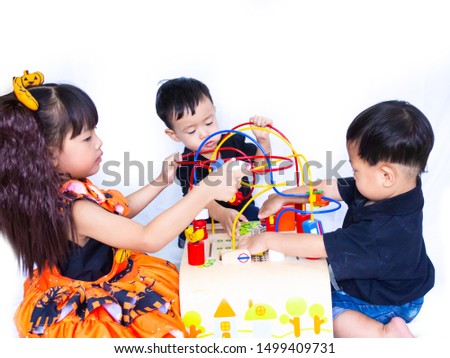 Two Asian little boy and girl play Wooden toys  sit on floor in white background , Sister and brother Play toys together