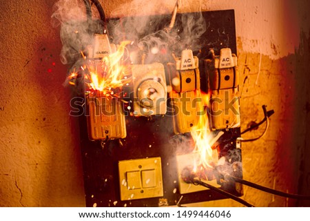 Blown short circuit electricity breaker,  fuse box damaged from high voltage overload, old bad installation condition over heat fuses home danger from fire burn Royalty-Free Stock Photo #1499446046