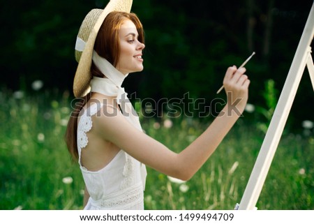 woman, in a straw hat, artist, paints, in a white sarofan, draws, in nature, brushes, young lady