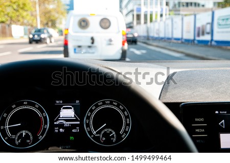 Car with adaptive cruise control (ACC) following and stopping behind another one Royalty-Free Stock Photo #1499499464