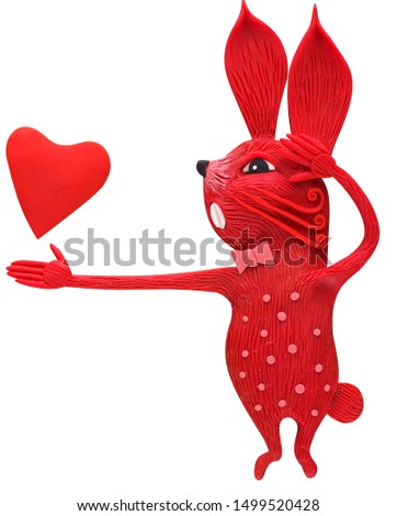 A loving and inspirational red hare confesses his love and forever gives his heart to his beloved half, molded from plasticine, for cards for Valentine's Day