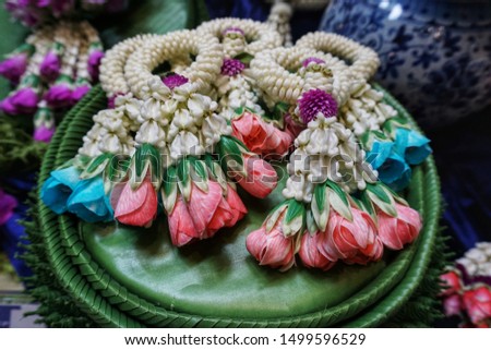Thai garlands are created by stringing various flower combinations together. Selective focus.