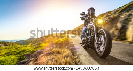 motorbike on the coast road riding. having fun driving the empty highway on a motorcycle tour journey. copyspace for your individual text. Royalty-Free Stock Photo #1499607053