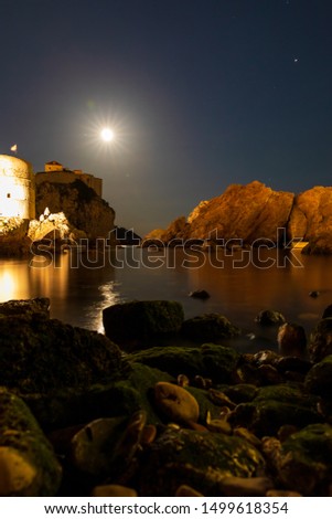 Stunning long exposure picture showing West Harbour and city walls in Dubrovnik, Croatia during full moon