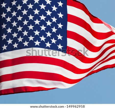 Fragment of a flag of America against the sky