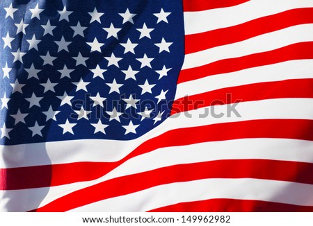 Sunlit American flag in the wind