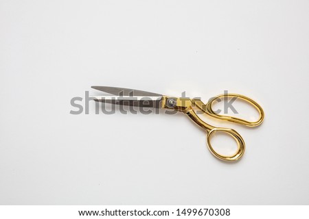 Scissors gold and silver color isolated against white background, copy space, top view. Tailor, barber concept Royalty-Free Stock Photo #1499670308