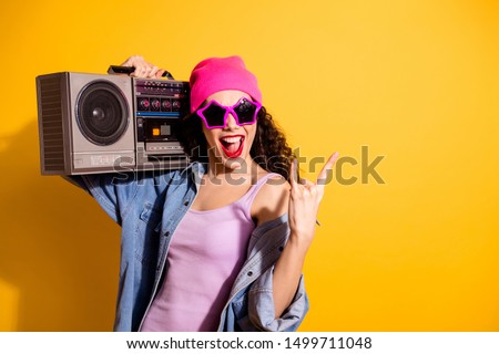 Photo of nice lady with tape recorder on shoulder listening metal song making horns symbol wear casual trendy clothes isolated yellow color background