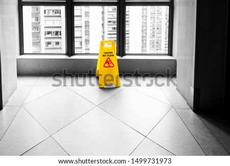 Wet floor caution sign in the corridor.