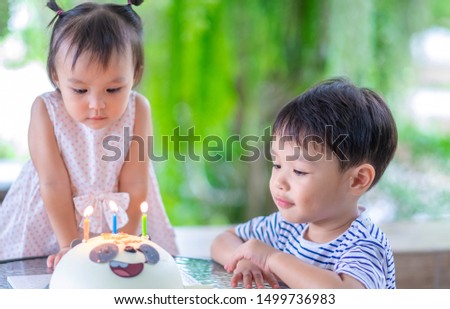 Little boy and girl with panda cake on  the table. Birthdays concept.
