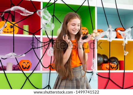 Happy Halloween, a girl enjoy the party in decorated house