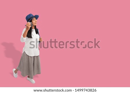 Tourist asian woman relaxing enjoy taking photo with camera isolated from background with copy space