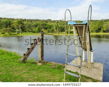 Wooden diving board and a slide by a lake in the countryside of Itamaraca Island - Pernambuco, Brazil Royalty-Free Stock Photo #1499755217