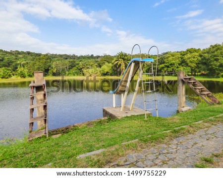 Wooden diving boards and a slide by a lake in the countryside of Itamaraca Island - Pernambuco, Brazil Royalty-Free Stock Photo #1499755229