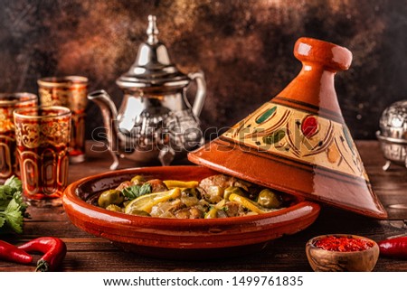 Traditional Moroccan chicken tagine with olives and salted lemons, selective focus. Royalty-Free Stock Photo #1499761835