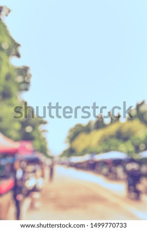 Vintage tone abstract blur image of Street day market in garden with bokeh for background usage .