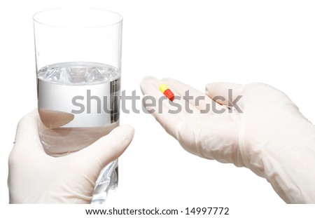 Helping hands in latex gloves give glass with water and pills, isolated, with clipping path, on white background