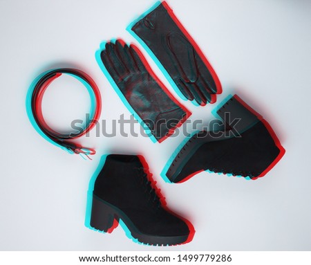 Fashionable women's shoes and accessories. Boots,  leather belt and gloves on gray background.  Vhs, glitch effect. Top view