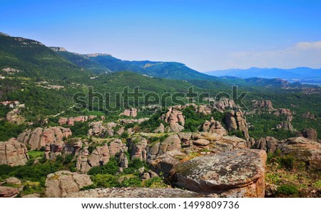 Scenic Bulgarian landscape with mountains and forests as seen from the Belogradchick Rocks, amazing view in the landmark rock formations of Bulgaria 