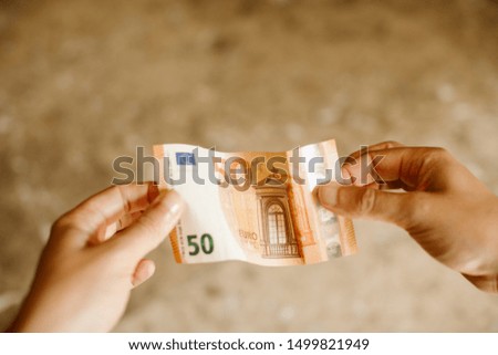 Close up of hands holding euro banknotes with selective focus.  