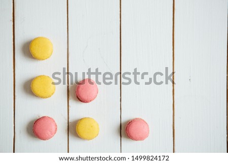 Sweet colorful French macaroon cookies dessert on white wooden table